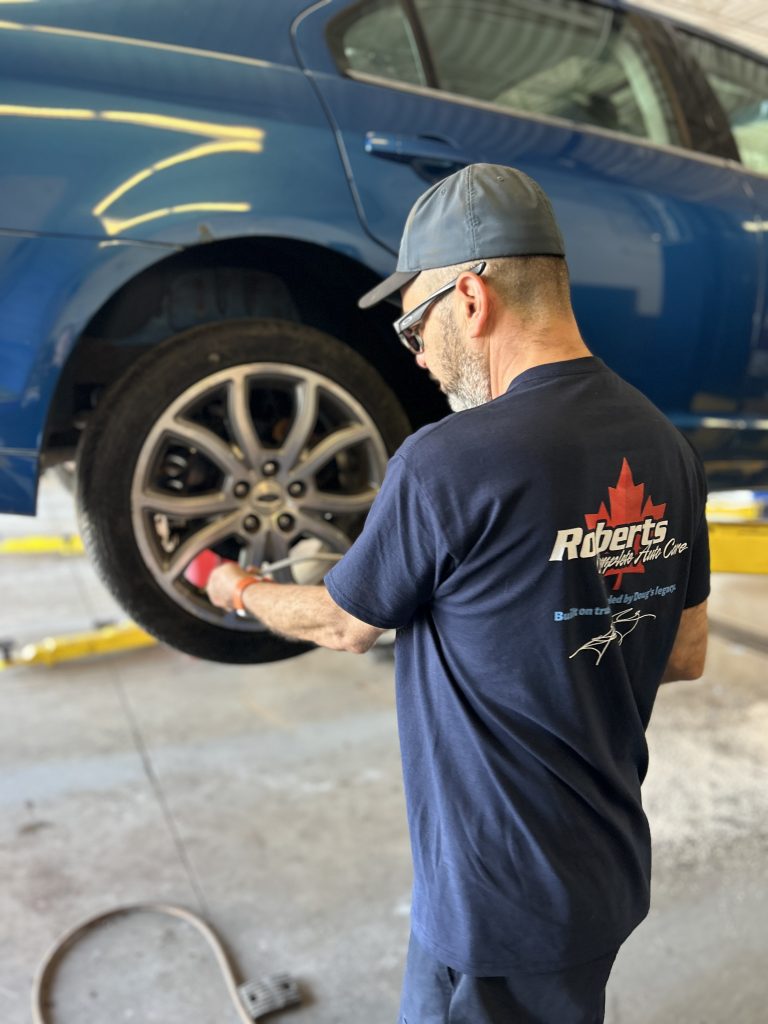 IMG_3587 Seasonal tire change Barrie — technician mounting tires at Roberts Complete Auto Care