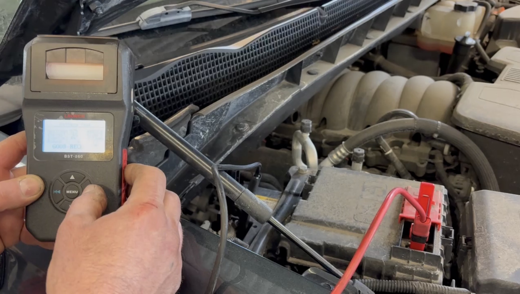 Fleet maintenance Barrie — technician inspecting vehicle battery under hood