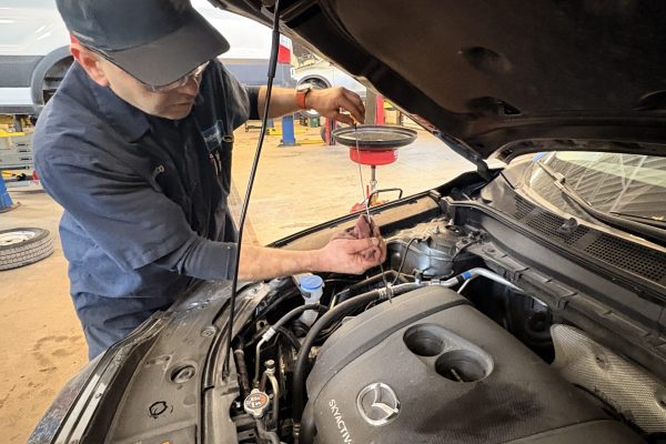 Oil Change Barrie - technician checking oil level at Roberts Complete Auto Care