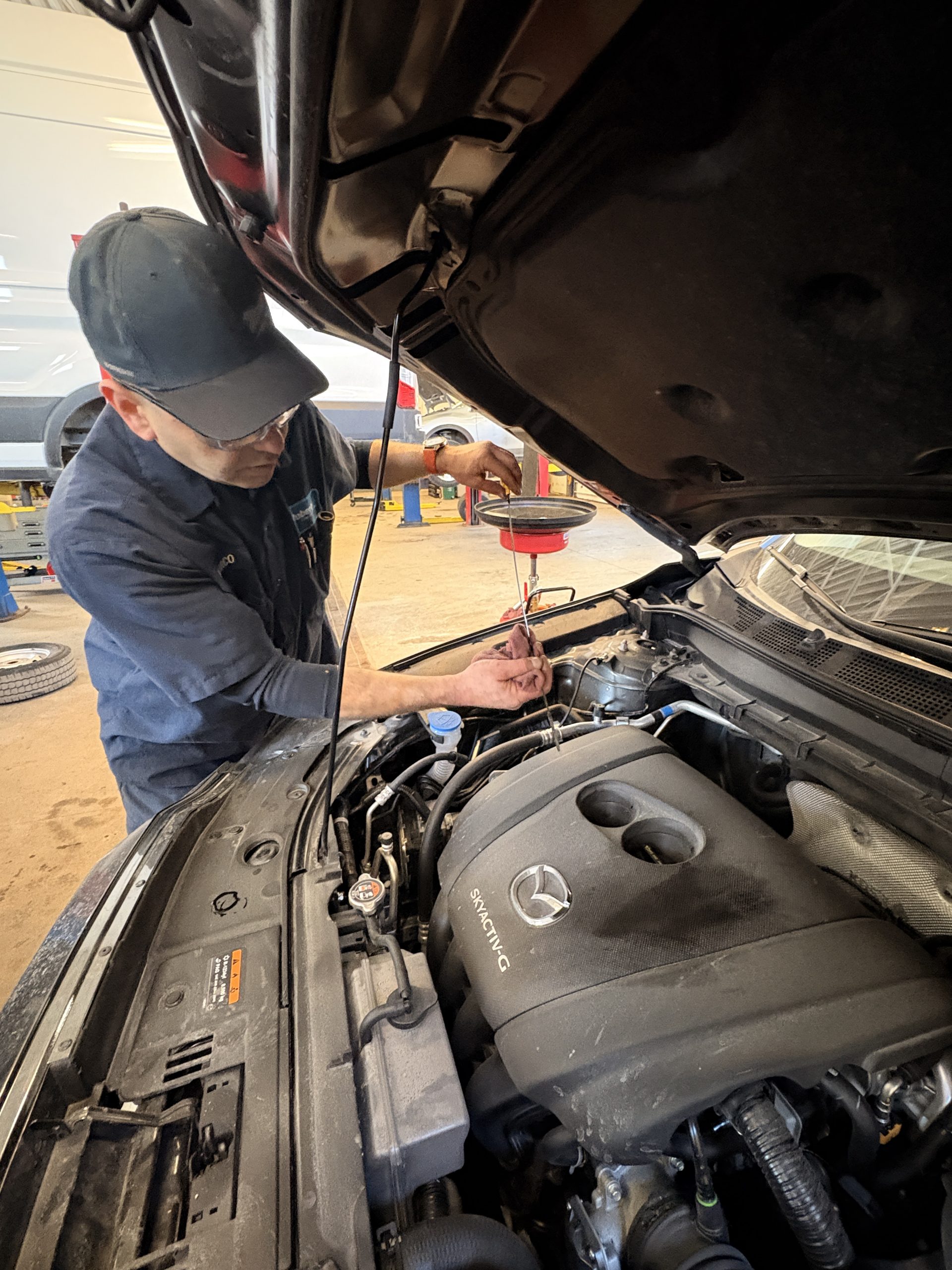 IMG_7473 Oil Change Barrie - technician checking oil level at Roberts Complete Auto Care