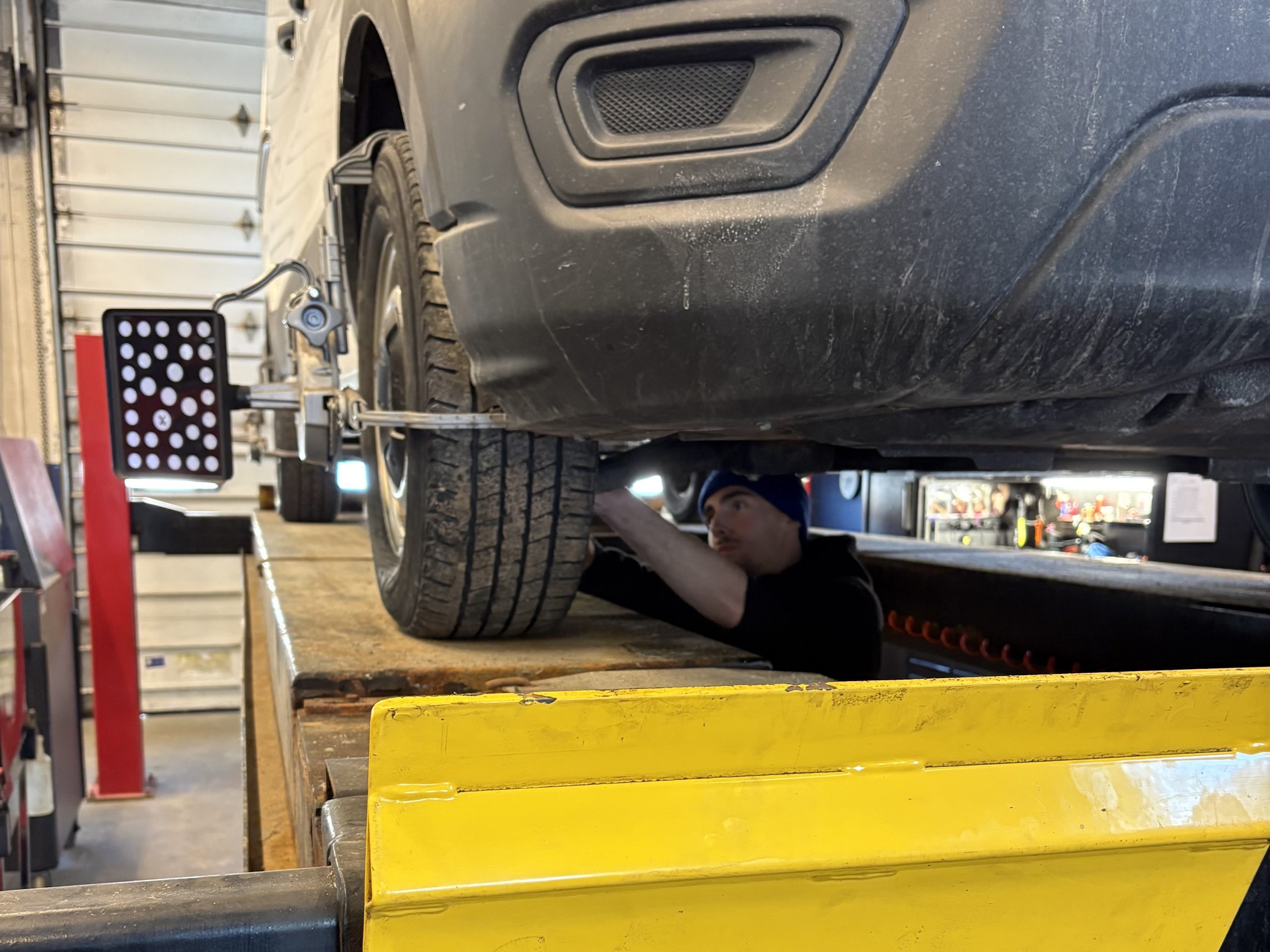 Wheel alignment Barrie - technician performing wheel alignment at Roberts Complete Auto Care